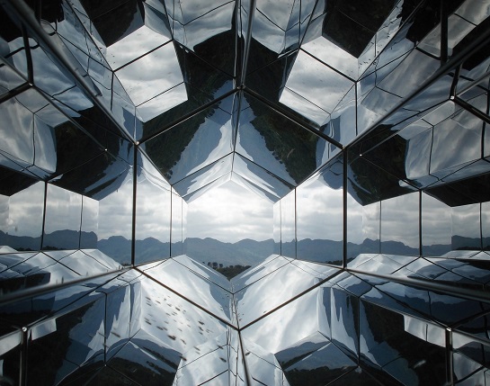 reflective hexagonal architectural element with a view to a distant horizon