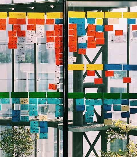 Colorful project post-its stuck to a window