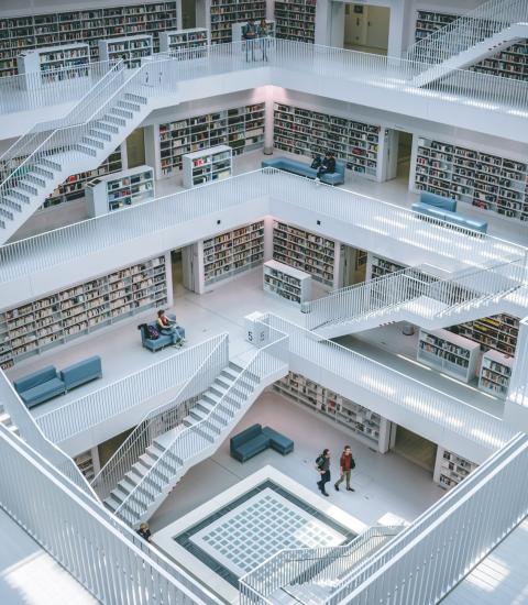 Library with white staircases and walls lined with books