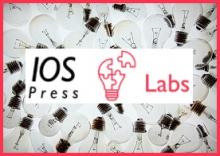 Labs pink lightbulb logo placed on top of a visual of lots of clear lightbulbs